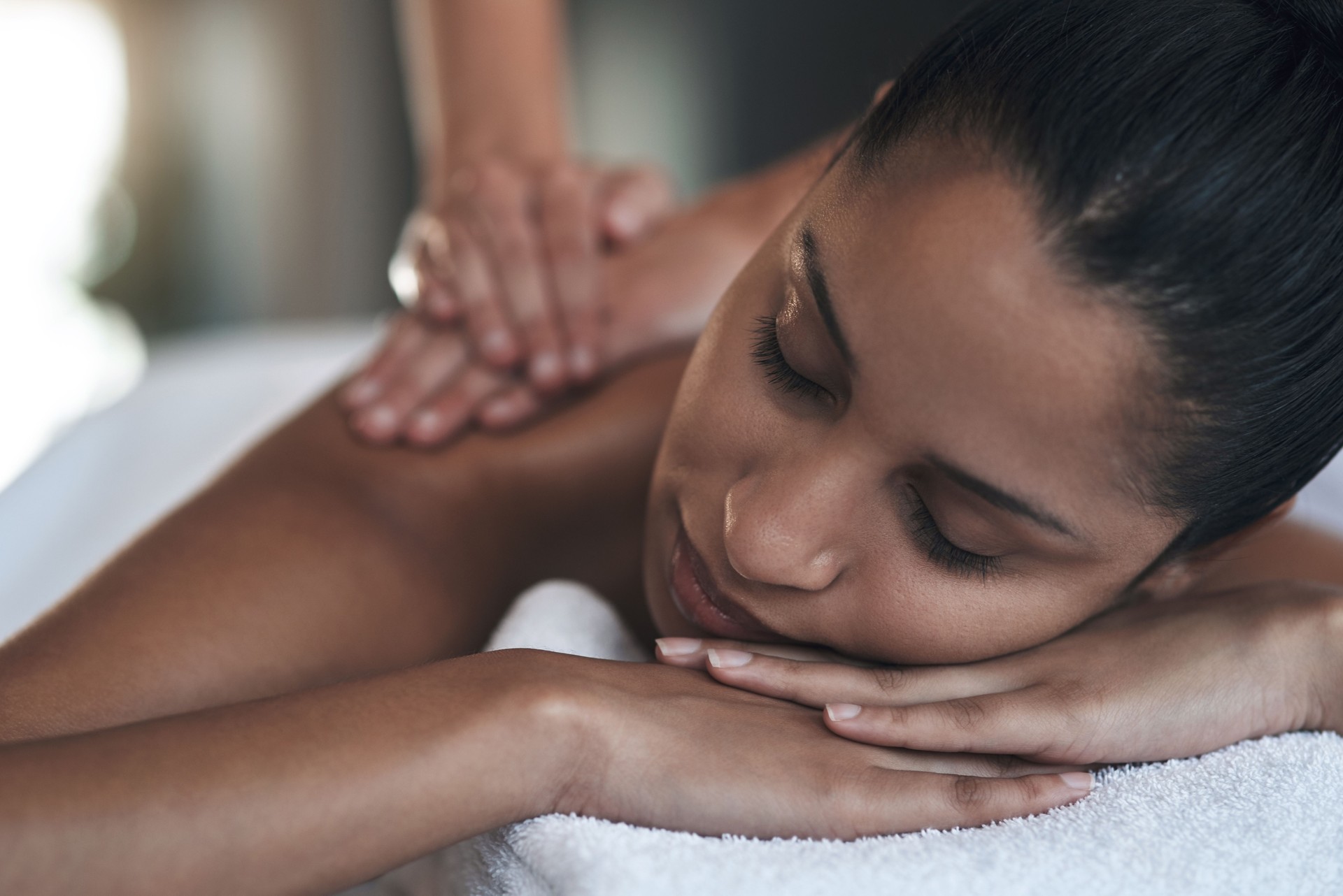 Shot of a young woman getting a back massage at a spa