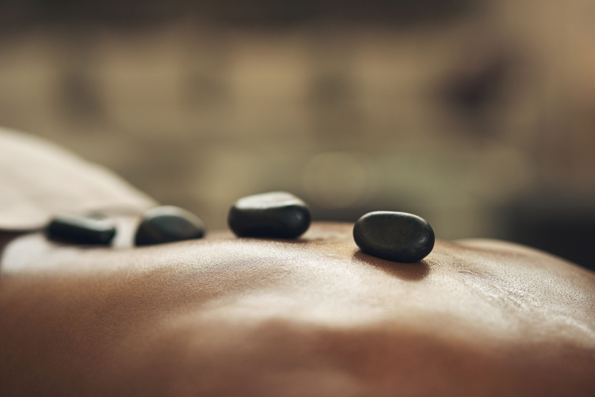 Cropped shot of a man getting a hot stone massage at a spa